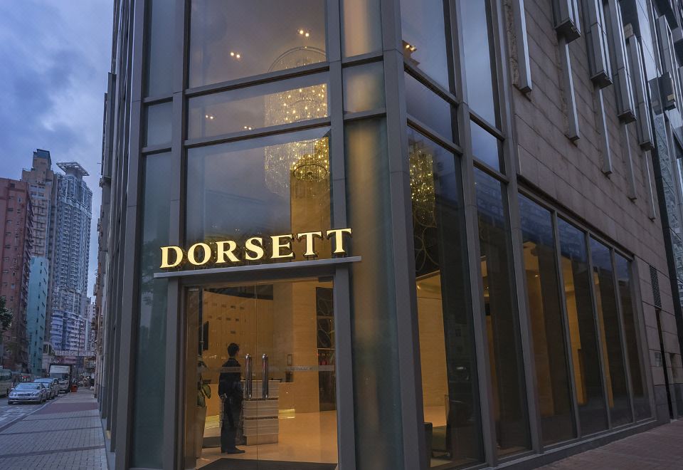 The hotel's front entrance features a glass facade and stone-clad doorways at Dorsett Mongkok Hong Kong