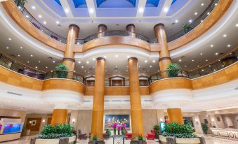The large building has multiple floors and features a lobby with a ceiling, as well as an atrium at Park Inn by Radisson Shanghai Downtown