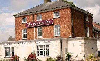 "a brick building with a red roof and the sign "" the aylesbury inn "" is shown" at The Pytchley Inn