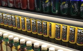 The store has a display of various types and kinds of products on shelves, including beer and soft drinks at MUYI Hotel Hongqiao Hub Shanghai