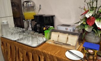 A table in the center with a variety of food and drinks available for purchase at De Elements Business Hotel KL