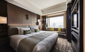 a luxurious hotel room with a king - sized bed and a large window overlooking the city at The Royal Park Hotel Iconic Osaka Midosuji