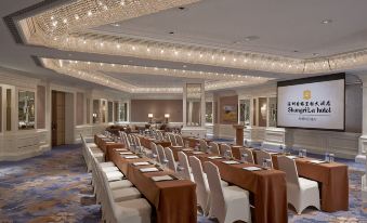 A spacious room is arranged with long tables and chairs for an event or conference at Shangri-La Shenzhen Hotel
