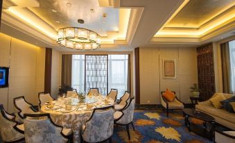 A room has been prepared for an event, featuring large windows and a table surrounded by chairs at KinDream Hotel