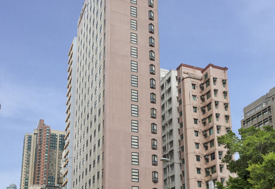 There is a large building in the center surrounded by other tall buildings, with one on top at Silka Seaview Hotel