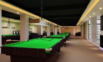 a large room filled with numerous pool tables , showcasing a variety of pool tables and chairs at The One Hotel
