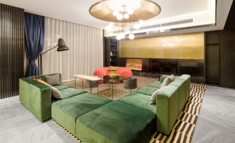 a living room with two couches and an open fireplace at CitiGO Hotel Sanyuanqiao Beijing