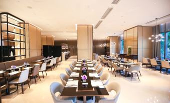 The restaurant features spacious tables and chairs arranged in the center, creating an open concept dining area at Hyatt Place Shanghai Hongqiao CBD