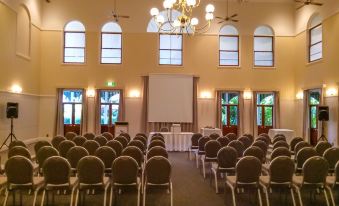 a large room with rows of chairs arranged in a semicircle , ready for a meeting or event at Cairns Colonial Club Resort