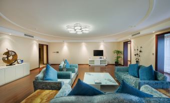 A spacious living room features contemporary furniture and a central entertainment center at Bai Fu Yi Hotel