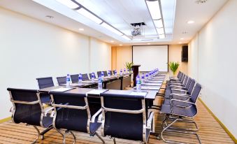 There is a spacious conference room equipped with long tables and chairs suitable for meetings and other business events at Beijing Xinqiao Hotel