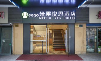 There is a front entrance to a restaurant with an oriental sign above it, as well as another doorway at Meego Yes Hotel