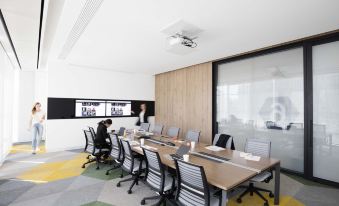 The conference room is equipped with a large table and chairs, suitable for meetings or playing board games at Jen Beijing by Shangri-La