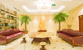 The lobby features a spacious and elegantly decorated room with couches and tables at Longyou International Grand Hotel