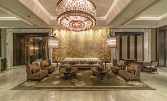 The lobby features a modern aesthetic with chandeliers and contemporary furniture in a spacious room at IFC Residence