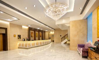 The lobby is clean and ready for hotel guests, with a large chandelier at Ramada Hong Kong Grand View
