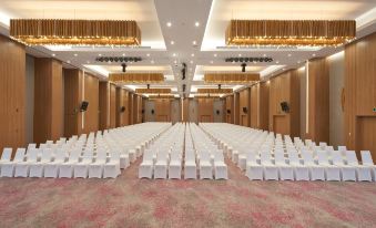 A spacious event room is arranged with rows of chairs facing the front at Holiday Inn & Suites Saigon Airport