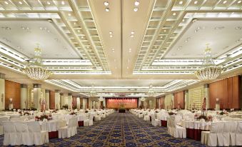 A ballroom in a large hotel is set up with tables and chairs for an event at Dong Fang Hotel