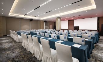 a ballroom with tables and chairs arranged for an event at Ramada Shanghai Pudong International Airport East Station