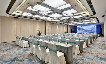 A spacious room is set up with rows of tables for an event at a hotel or conference at Global Hotel