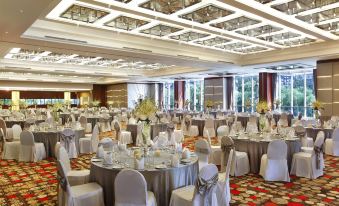 A ballroom is arranged for an event, with tables and chairs placed in the center at Kempinski Hotel Beijing Yansha Center