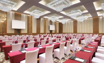 a large conference room with rows of chairs arranged in a semicircle , ready for a meeting at Sheraton Qinhuangdao Beidaihe  Hotel