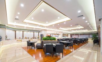 a large dining area with wooden floors and chairs arranged in a row , creating an elegant atmosphere at Millennium Harbourview Hotel Xiamen