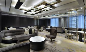 a large , modern living room with multiple couches and chairs arranged around a coffee table at Caesar Park Hotel Banqiao