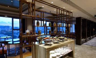 a modern restaurant with a dining table set for breakfast , filled with various food items and utensils at Lakeside Hotel