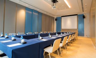 a large conference room with multiple tables and chairs arranged for a meeting or event at Holiday Inn Express