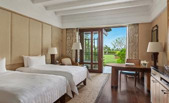 a modern hotel room with a large bed , wooden floor , and a view of the outdoors through a sliding glass door at Shangri-La Boracay