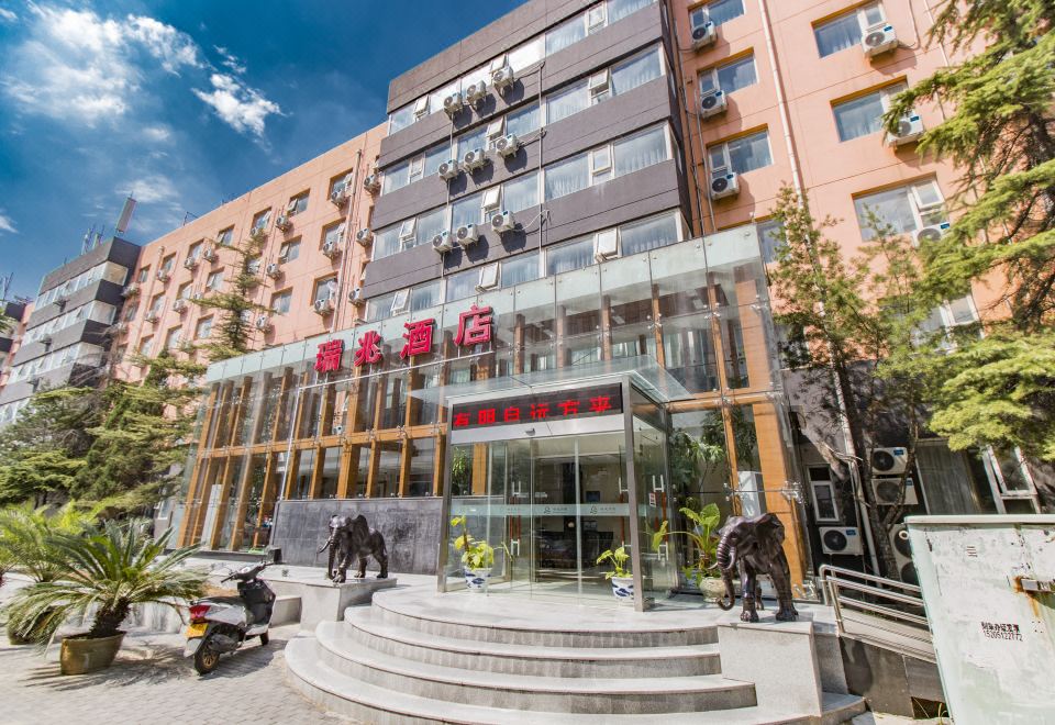 The hotel in an urban setting has a front view and entrance with large glass windows at Ruizhao Hotel (Beijing Guomao)