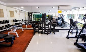 a gym with various exercise equipment , including weights and benches , is shown in the image at Kacha Resort & Spa, Koh Chang