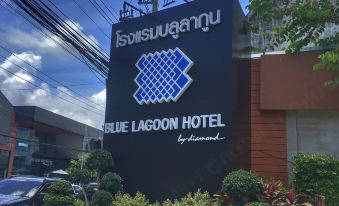 a black sign with white and blue text for the blue lagoon hotel is displayed in front of a building at Blue Lagoon Hotel