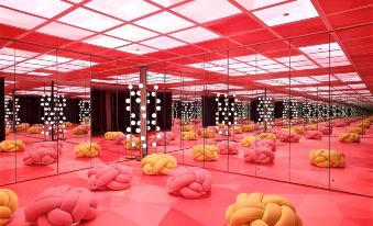 a room filled with pink and yellow bean bags , creating a vibrant and playful atmosphere at Just Sleep Ximending