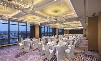 A ballroom in the hotel is prepared with tables and chairs for an event at Hilton Garden Inn Shanghai Hongqiao NECC