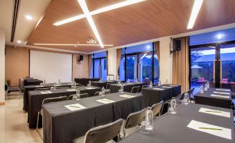 The conference room is arranged with tables and chairs for events or social functions at The Zense Boutique Hotel