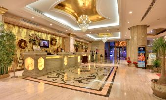 a luxurious hotel lobby with a marble floor , a reception desk , and a television mounted on the wall at Relax Hotel