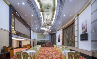 a large , elegant banquet hall with multiple dining tables and chairs arranged for a formal event at City Hotel
