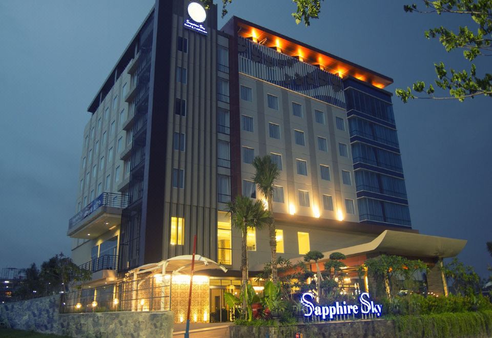 "a large building with a blue and white sign that reads "" sapphire 's "" prominently displayed on the front" at Sapphire Sky Hotel & Conference