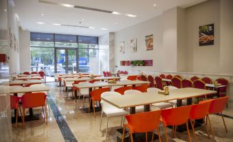 The restaurant has a dining room in the center with tables and chairs specifically designed for business luncheons at Rayfont Hotel & Apartment Chengdu