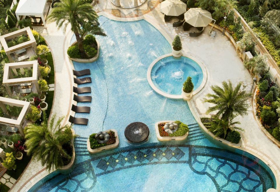 An aerial view showcases the pool and water park of a hotel or resort that offers multiple swimming options at The Langham, Shenzhen