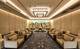 A large room with rows of seating along the wall features art deco design at Hotel Equatorial Shanghai