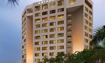 At night, there is a hotel in the foreground with a brightly lit skyline in the background at Aryaduta Bandung