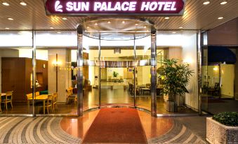 a hotel entrance with a red carpet leading to the entrance , and a glass door on the right side at Sun Palace Hotel