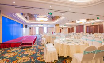 A ballroom has been prepared with tables and chairs for an event at the hotel or conference at Longyou International Grand Hotel