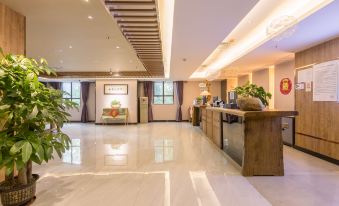 The lobby features a clean and modern design, with a spacious reception desk located either in front or to one side at Nuomo Hotel