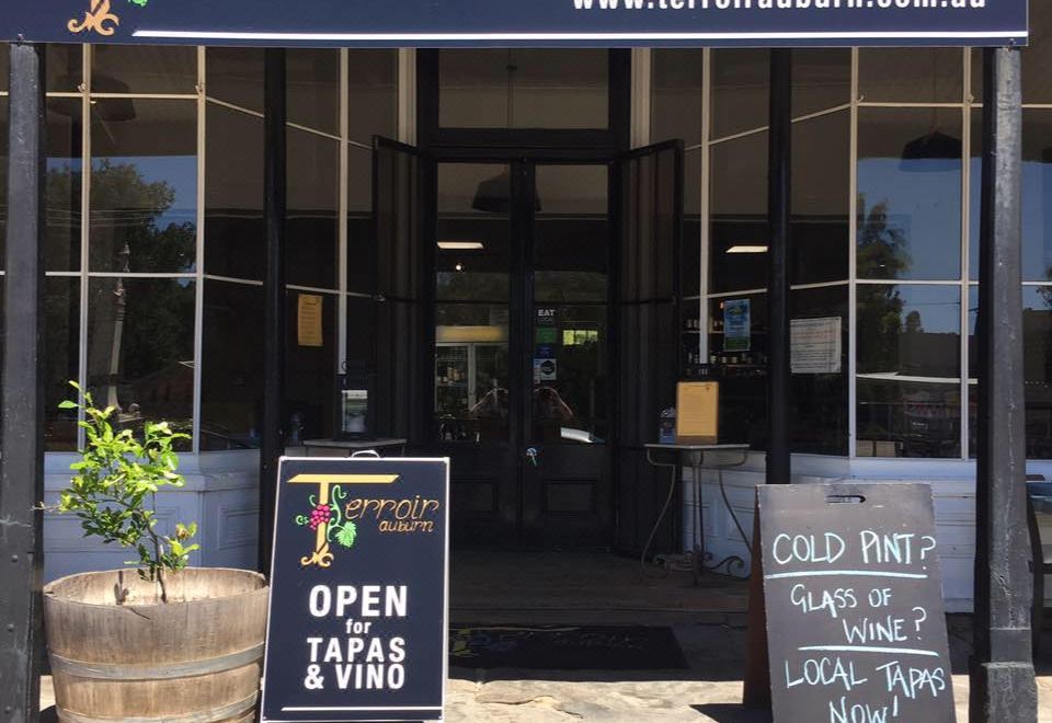 "a storefront with a sign that says "" leo cafe "" and "" cornwall eatery "" and two potted plants in front" at Terroir Auburn