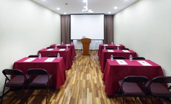 a spacious room arranged with long tables and chairs for hosting events or functions at Zhenyue Hotel