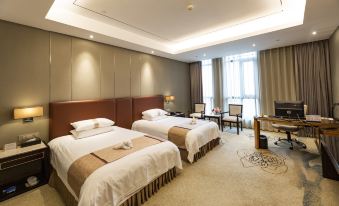 The bedroom has two large beds, a table, a desk, and a window that overlooks the front yard at Sorl Bund Hotel Ruian